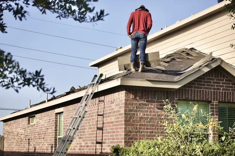 Professional roofer working on a residential roof in Tusseyville